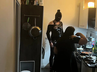 Fetish babe dominates her friend in kinky kitchen encounter