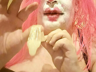 TV clown slut sucking out the contents of a condom