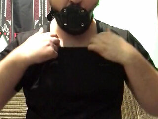 A man puts a gag in his mouth and an anal plug