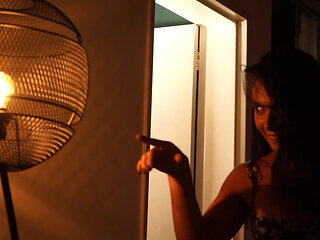 Sensual Latina Doing a Striptease in Low Light