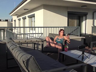 Redheaded amateur gives a sensual oil handjob in the sun