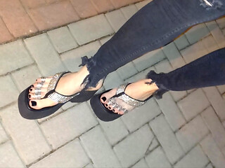 I wear platform flip-flops and tight jeans, showing off my feet.