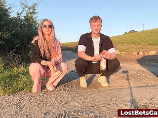 Alex and Nicole play strip bottle flips outdoors