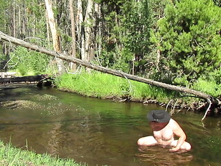Bathing naked in the creek.