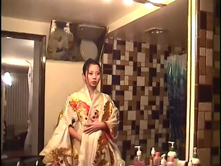 Man shoves cock in asian's mouth while she lays in bed