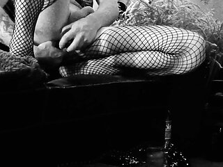 A winded-up guy in fishnet stockings does his ass.
