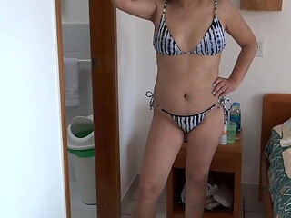 On the beach, my stepmom in a bikini shows me her hairy pussy, ass, and tits.