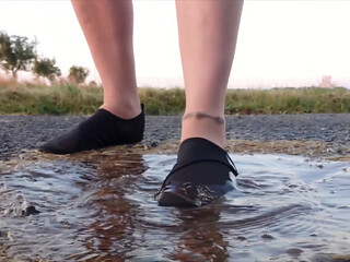 Bright Pantyhose and Beach Shoes in Puddle