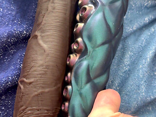 The latex titty slut pushes three monstrous dildos in a row!