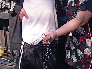 A neighbor holds my dick while I pee and then sucks it in public