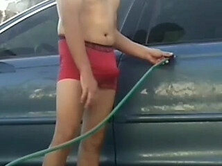 Jesus in red boxer washing his jaguar car