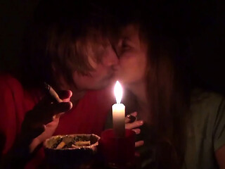 Couple smoke next to candle