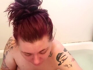 Naked milf smoking a cigarette while applying makeup in the bath
