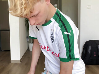 blond soccer boy shows his full diapers
