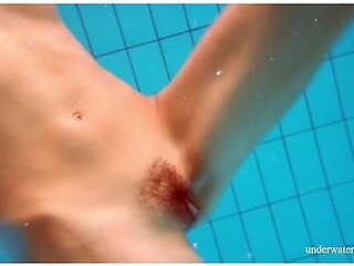 Gorgeous redheads hairy pussy glistens underwater