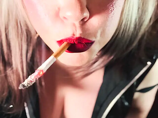 MILF in PVC teases with a cigarette