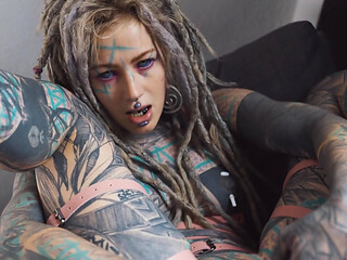 Gorgeous tattooed girl fucks her ass with a big dildo
