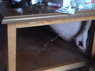 John is pissing on the table shelf