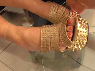 Mistress lets her slave lick her golden shoes