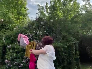 Dressed in a white lace dress to hang the laundry