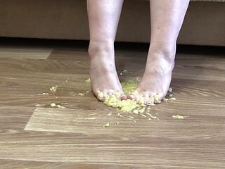 Naughty MILFs crushes banana with her feet