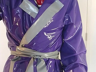 Putting on latex saint priest robe coat and rubber cape over schoolgirl sailor uniform, layers