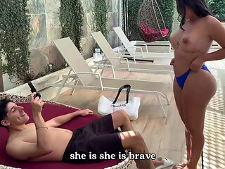 Curvy brunette bounces her fat butt on a tourist's cock, by the hotel pool