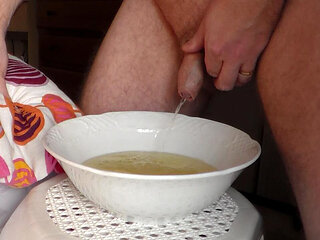 John is peeing into a porcelain bowl