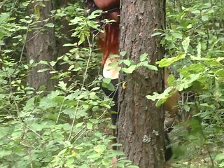 Blowjob in the Woods From the Redheads in a Leather Mask