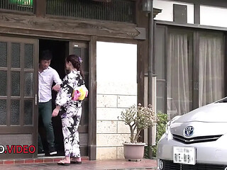 Japanese beauty Maya Kawamura wraps herself in a traditional kimono.