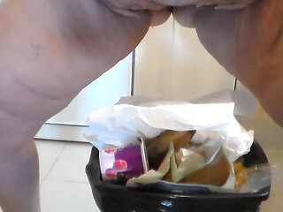 Jen is peeing into the trash can