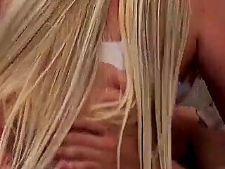 Hot Blonde in a June Festival Costume Sits Down Sexy