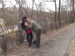 It's cold in the park and the young brunette with small natural tits gets warmed up by an old man and swallows all the cum