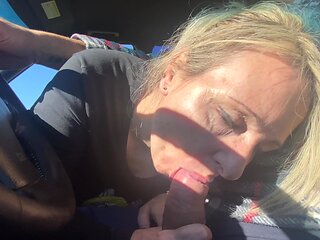 A woman is having a lot of fun in her car with a man.