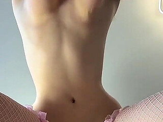 Slim Beauty with Massive Natural Tits in Pink Fishnet Stockings Teases Her Ass From Behind