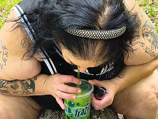 Sucking on a Straw in the Woods Squirting on Tree on Her Knees
