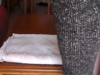 John is taking a big piss on the towel on the table