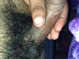 A Indian young boy is playing with his penis inside a blanket