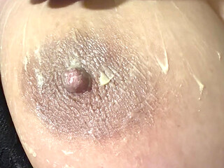 Hot sexy blonde fills her huge nipple with cream