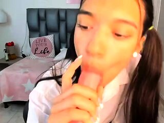 Cute amateur teen girl toying her pussy in bed on cam