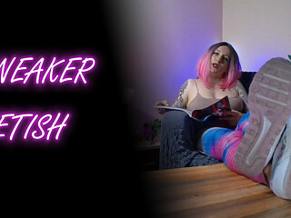 Lady Angela Reading a Magazine and Prompting Her Sneakers Bottoms on a Coffee Table