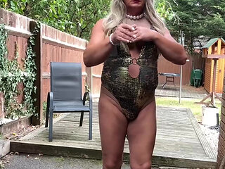 Sexy Crossdresser kellycd2022 in gold swimsuit and heels clearing leafs