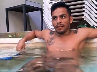 Tattooed Latino with a nice torso relaxing in the pool