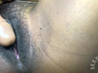 Sexy black girl rubs a dildo on her pussy and cums hard