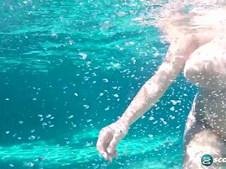 Brunette and blonde girlfriends show off their big tits in the pool