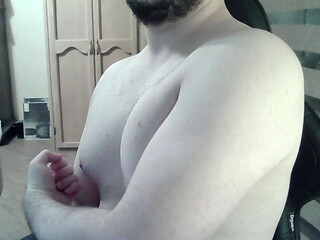 Muscular jock flexes his muscles on can