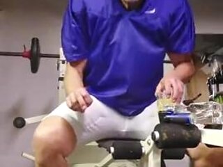 Football  practice uniform and coach relaxing after team leaves