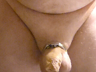 putting on a metal chastity cage