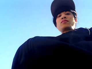 Freeballing in public, this twink walks outdoors commando, no underwear beneath his black Adidas tracksuit, Campus sneakers, while out cruising