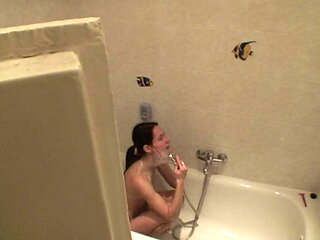 Sexy brunette teen is taking a shower